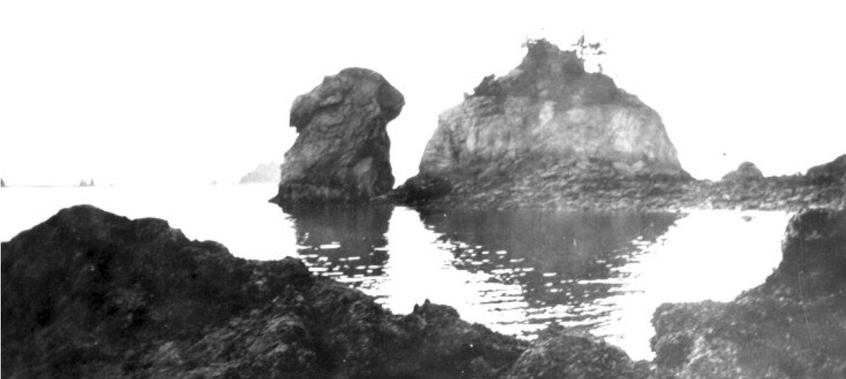 Two rocks across a small bay that look like the head and back of a camel