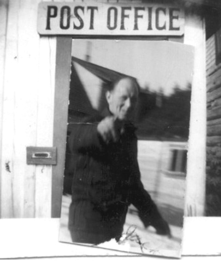 Two photos. Man pointing at the photographer pasted over the doorway of the post office