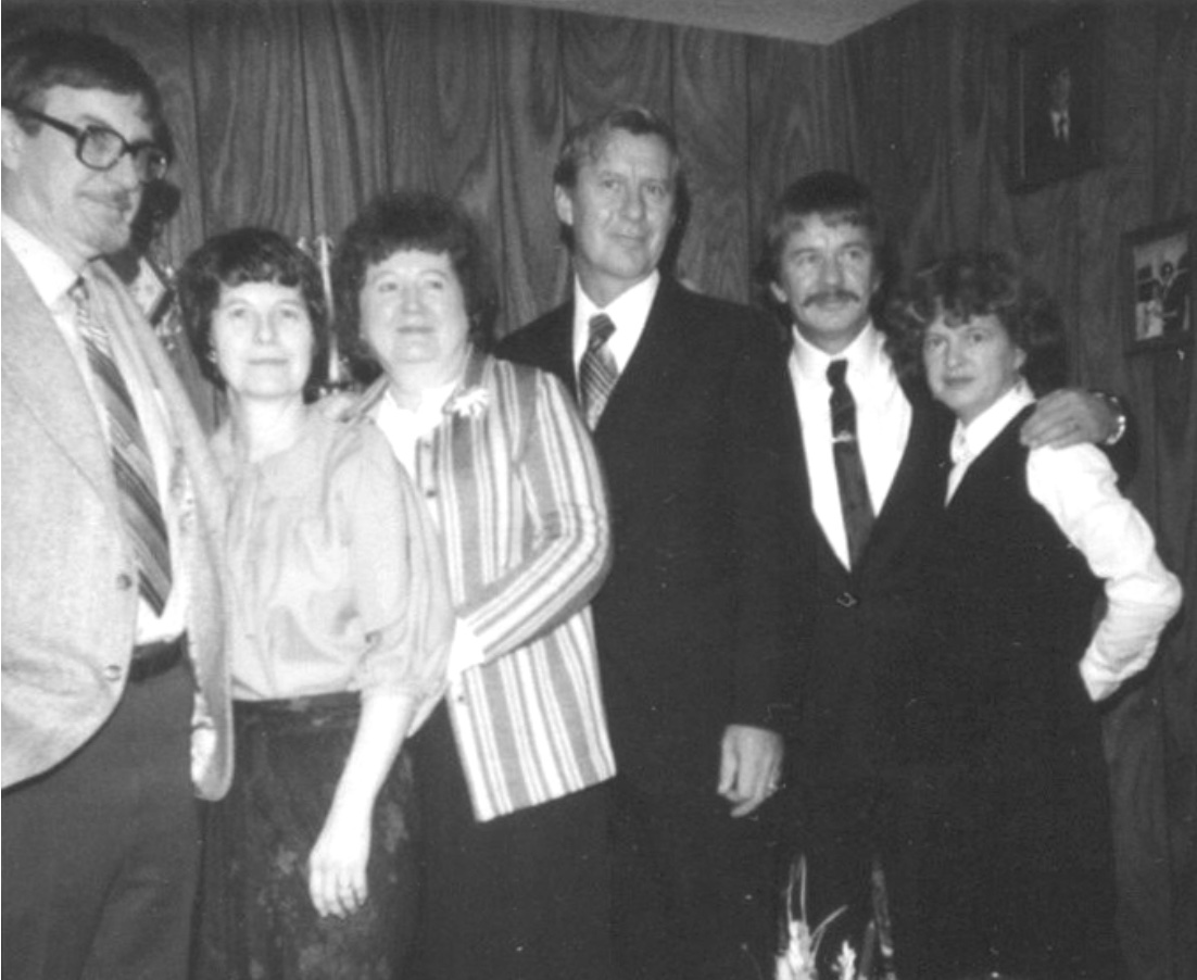 Six adults, the men in suits and ties - Thomas, Mae, Deloris, Andrew, Arthur, Lettie
