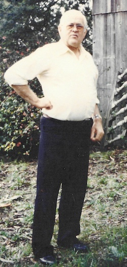 Frederick Lee Sharp, standing in a back yard.