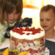 Neices Caroline and Sara considering a cake
