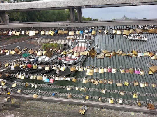 Locks on the Passerelle de Solferino, a pedestrian bridge between D’Orsay and the Tuileries Gardens. Lovers write their names on the lock, attach it to the bridge, and throw the key in the river.
